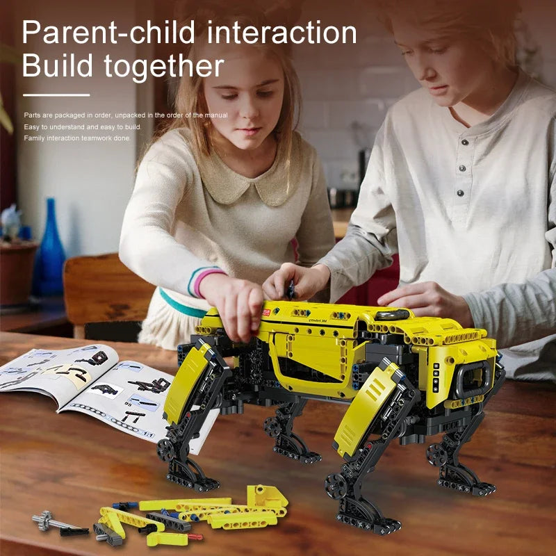 Two children building a yellow and black robot model together on a wooden table.